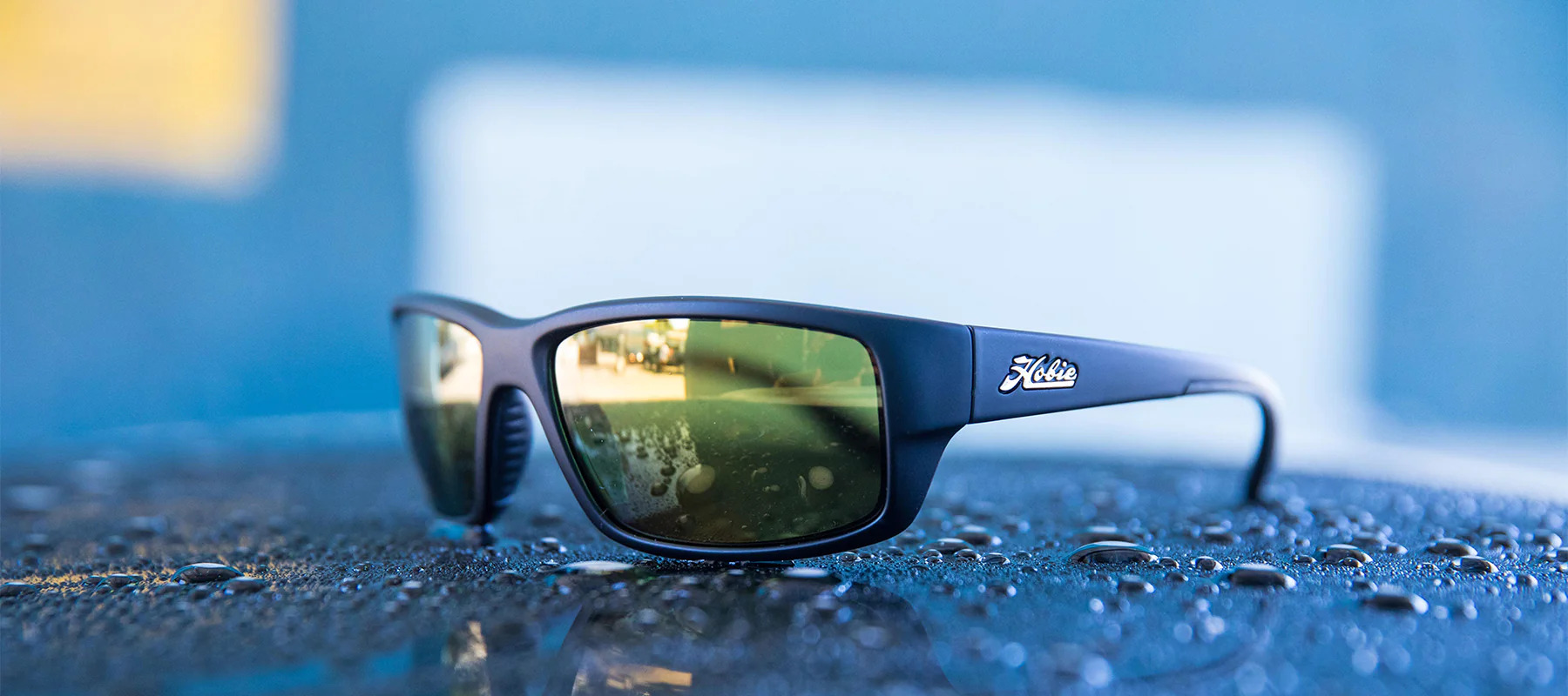 Hobie Eyewear Snook fishing sunglasses on a surface with water droplets